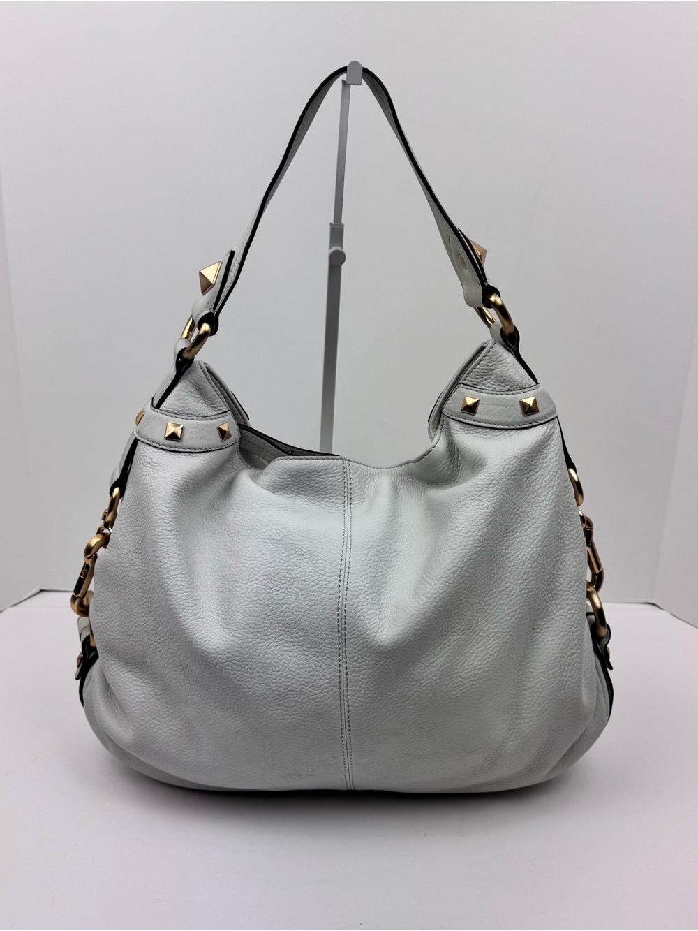 B. Makowsky Leather Ivory Hobo handbag. Gold-tone stud accent hardware.